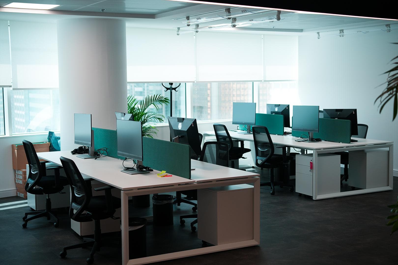 Open-plan workspace with networked workstations and dual monitors