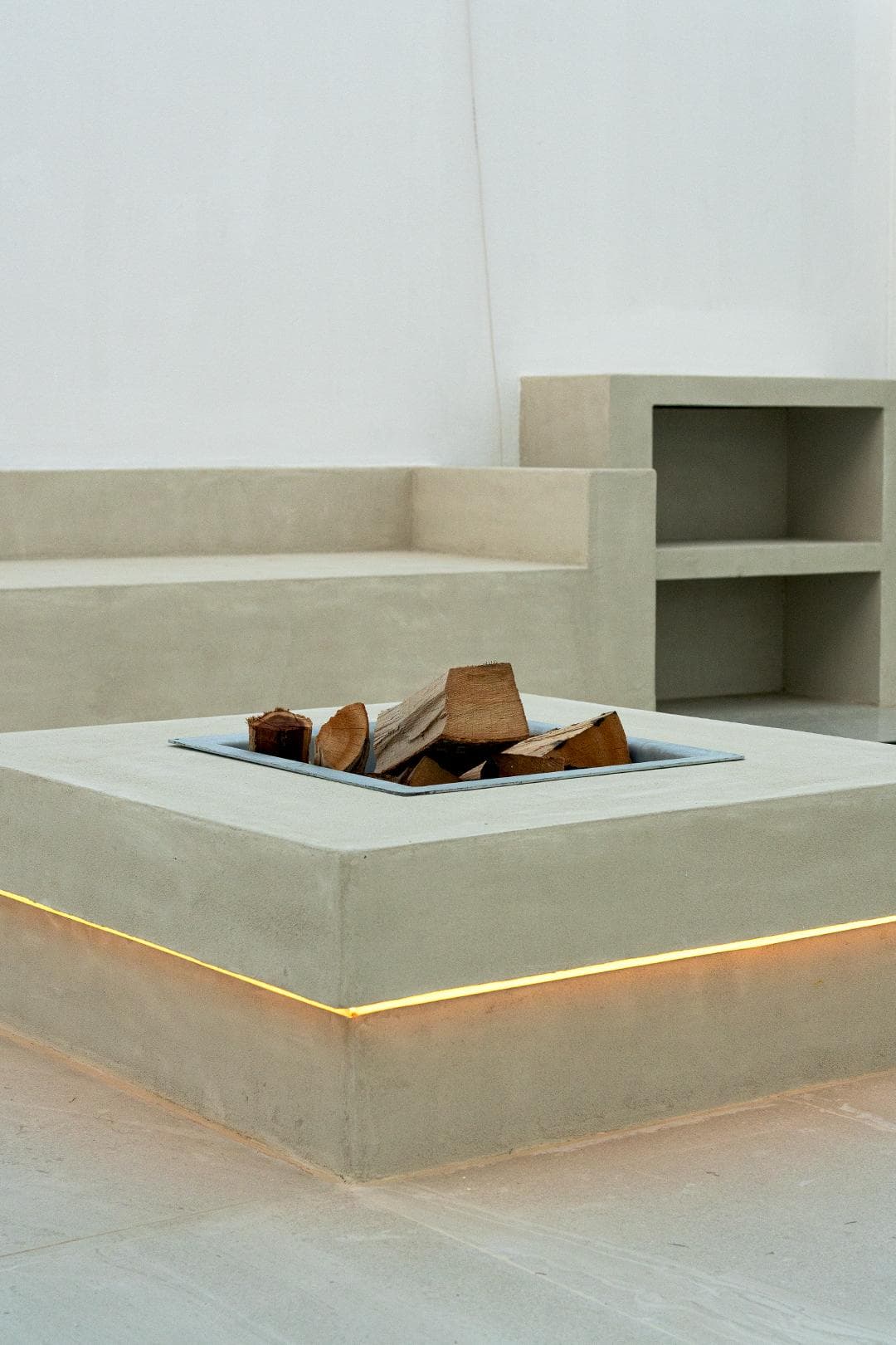 Cast-concrete fire pit bench with recessed LED strip lighting